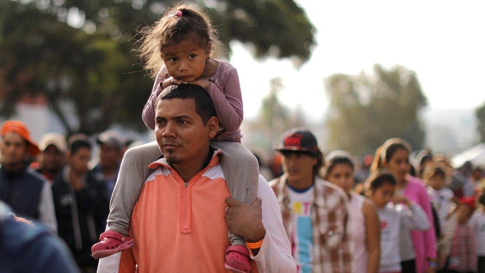 Members of a caravan from Central America trying to reach the United States queue for food outside in temporary shelter in Tijuana, Mexico, November 24, 2018