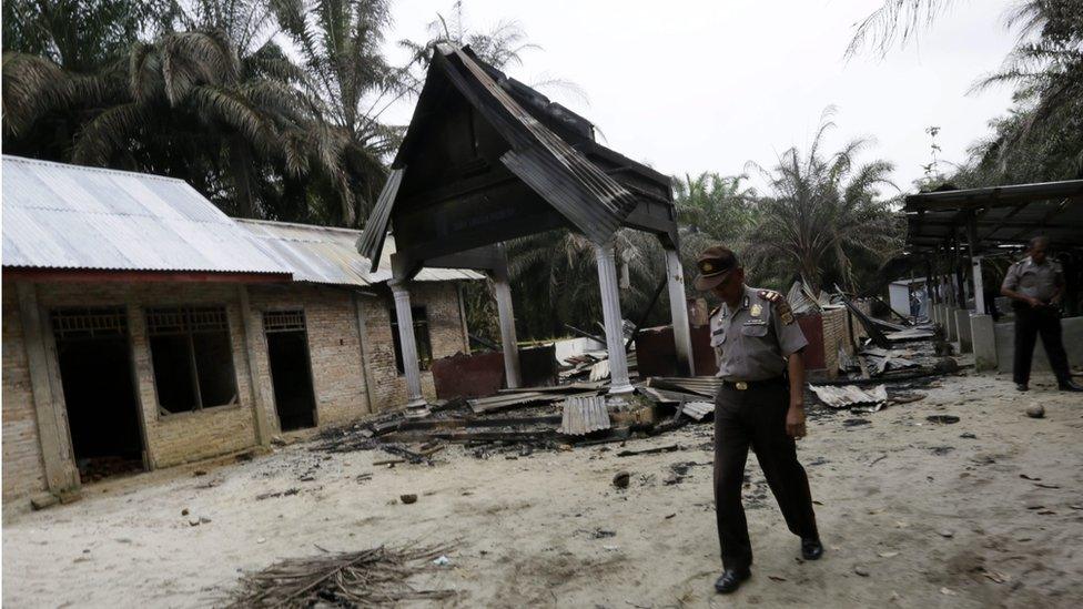 Security forces inspect the scene of a burned Church in Aceh Singkil, Indonesia, 14 October 2015