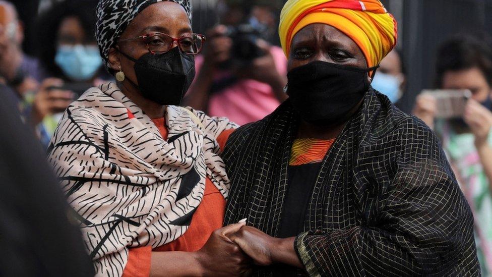 Archbishop Desmond Tutu's daughters Nontombi Naomi Tutu and Thandeka Tutu watch as the casket containing his body arrives at St Georges cathedral for his lying in state, in Cape Town, South Africa, December 30, 2021.