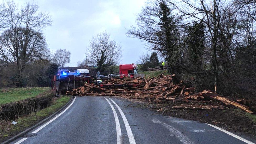 The overturned timber lorry