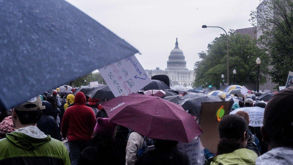 Protesters under umbrellas