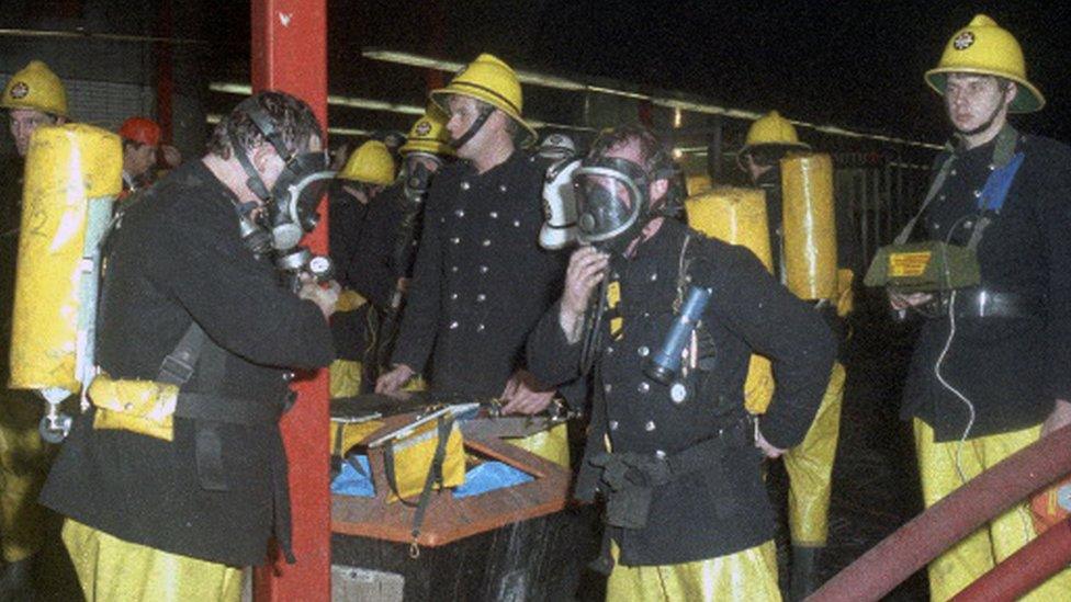 Firefighters outside King's Cross station on 18 November 1987