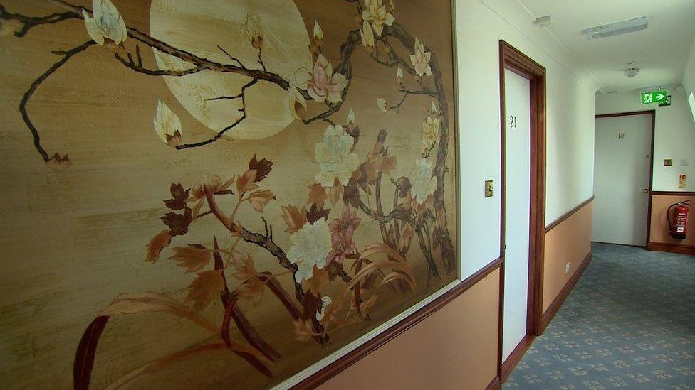 Hallway with artwork and doors