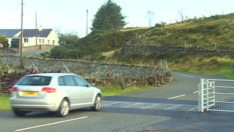 A car goes over a sheep grid