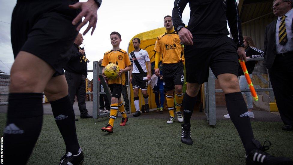 Annan and Edinburgh players enter the pitch