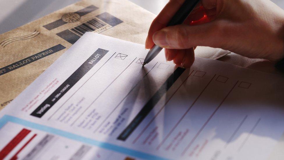 Hand filling in ballot paper