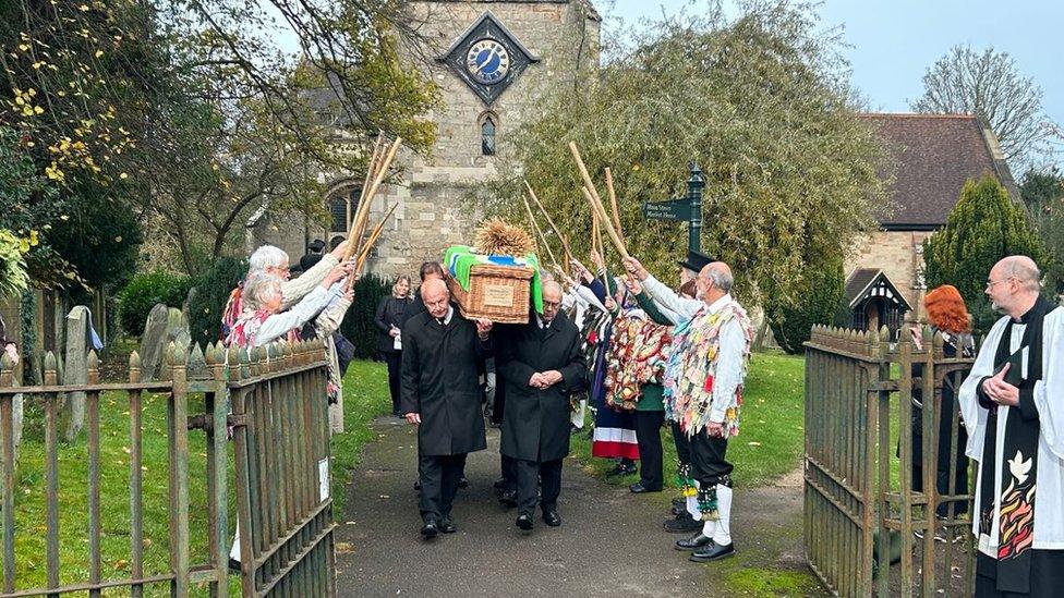 Four Morris sides from Gloucestershire formed a guard of honour with raised sticks outside the church