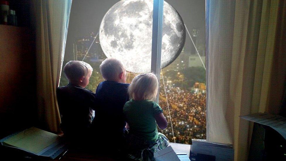 Moon balloon superimposed outside a window