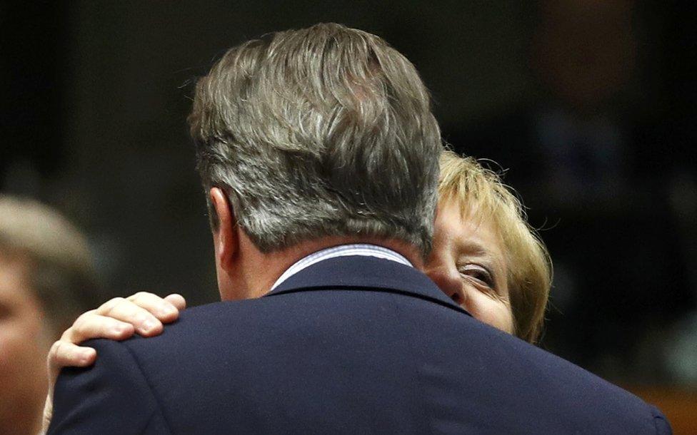 UK Prime Minister David Cameron is embraced by German Chancellor Angela Merkel in Brussels, 28 June