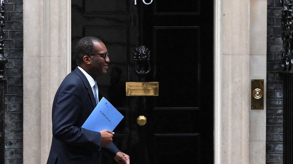 Chancellor Kwasi Kwarteng walks past the No 10 front door