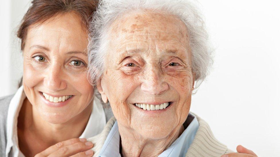 An elderly woman and her carer