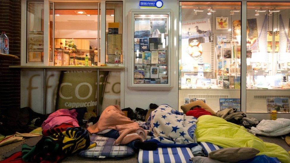 Migrants sleep Flensburg railway station in Germany on their way to seeking asylum in Denmark - 2015