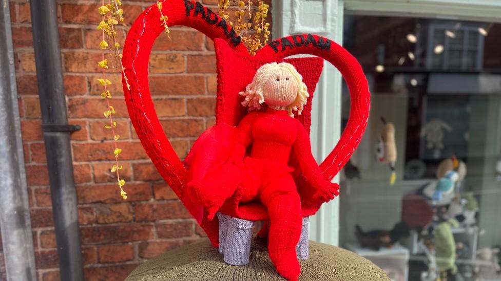 Knitted Kylie postbox topper in Syston