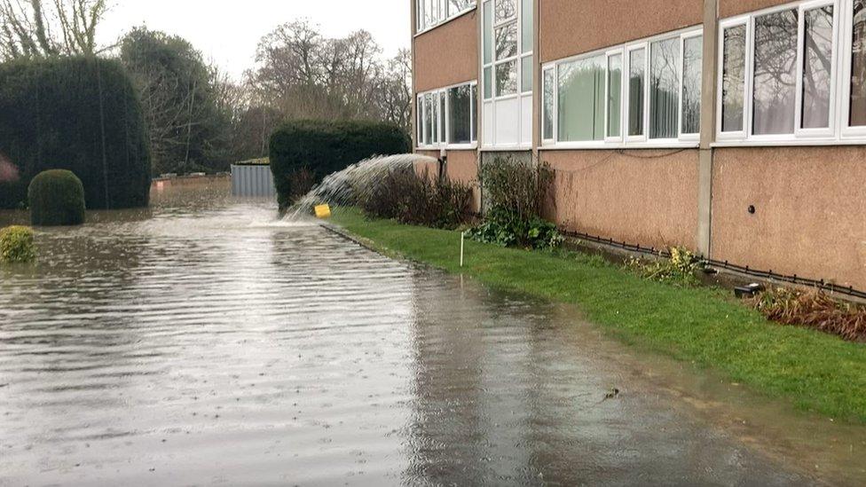 water being pumped out of a block of flats