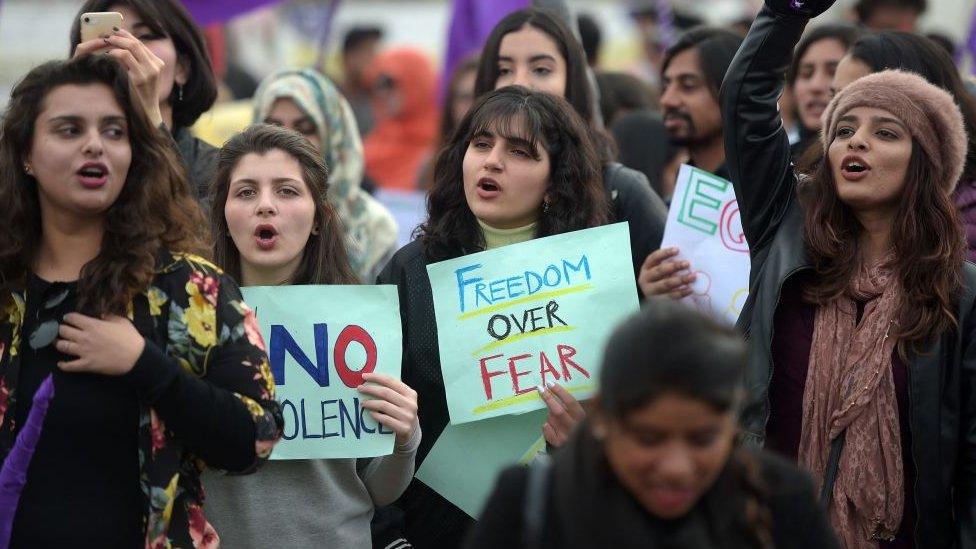 Pakistani civil society activists carry placard and shout slogans during a rally for women rights on International Women's Day in Islamabad on March 8, 2019.