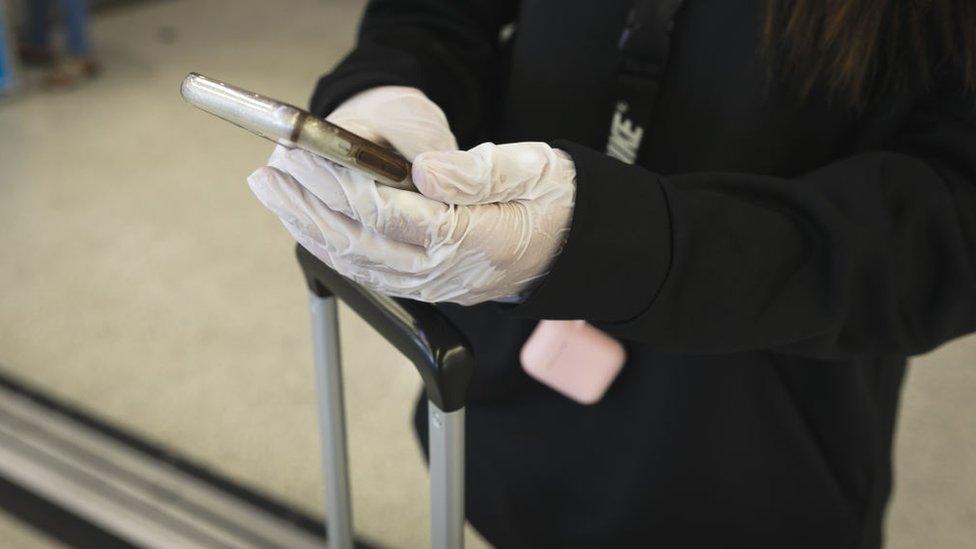 Air passenger wearing gloves