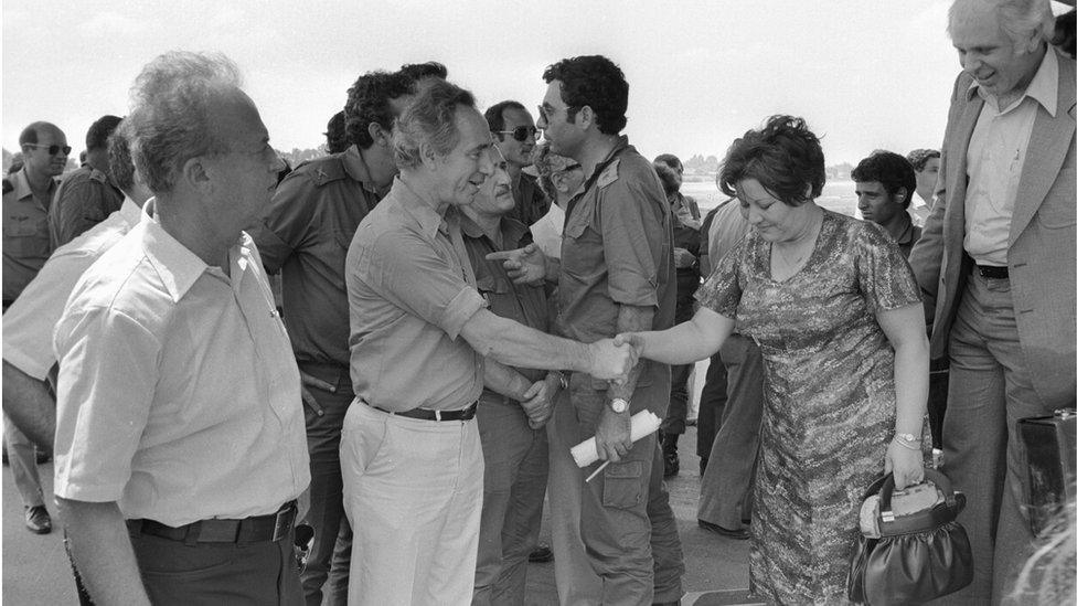 Yitzhak Rabin (left) and Shimon Peres welcome hostages back to Israel