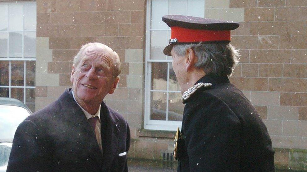 Prince Philip is greeted by Lord Lieutenant William Hall at a snowy Hillsborough Castle in February 2004