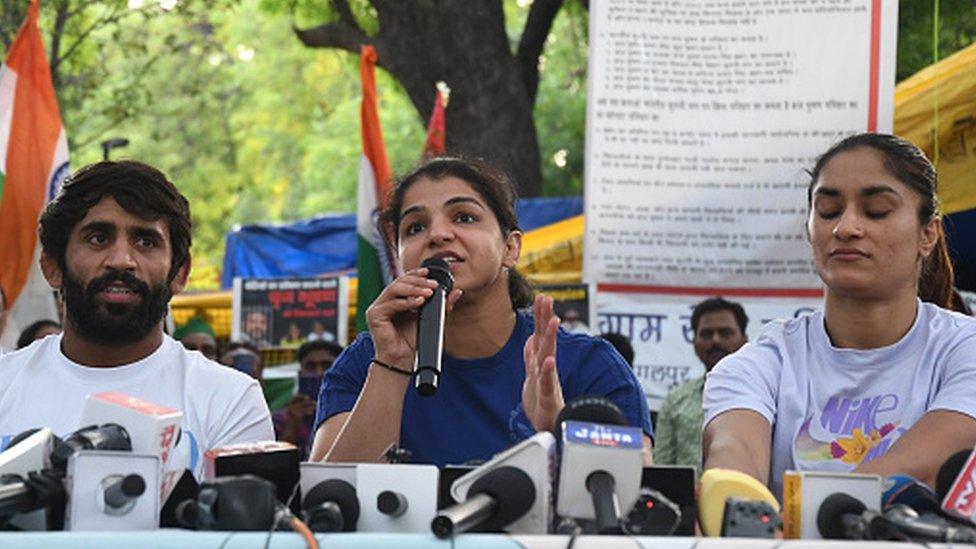 Wrestlers Bajrang Punia, Sakshi Malik and Vinesh Phogat addressing a press conference at Jantar Mantar on May 26, 2023 in New Delhi