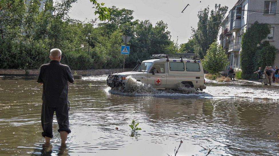 A Red Cross vehicle drives through Kherson