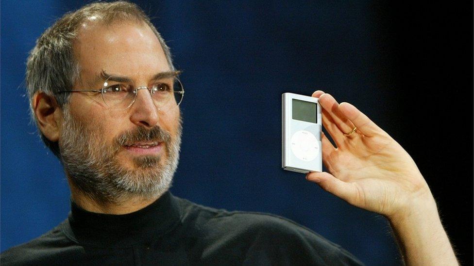 Steve Jobs holding an iPod mini