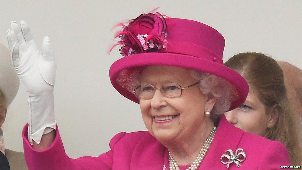 The Queen waving while watching the carnival