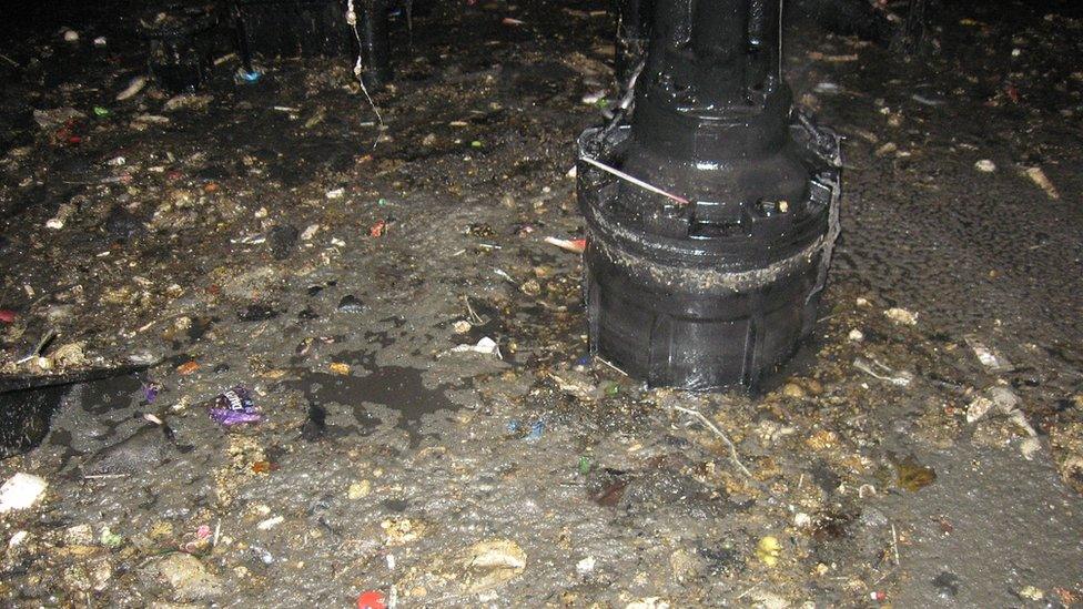 Inside the cavern with sludge and rubbish piled up