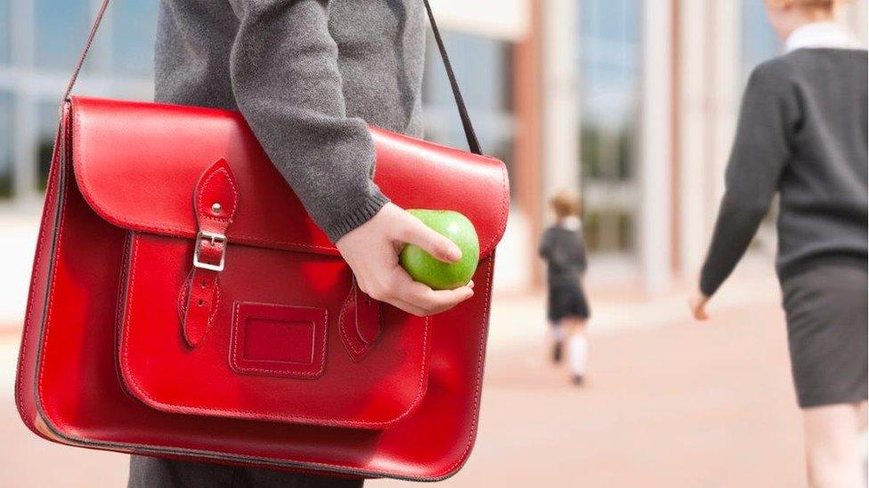 Child with red satchel