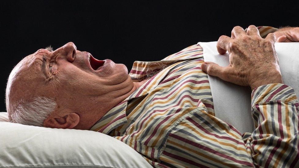 An elderly man shouting out in his sleep