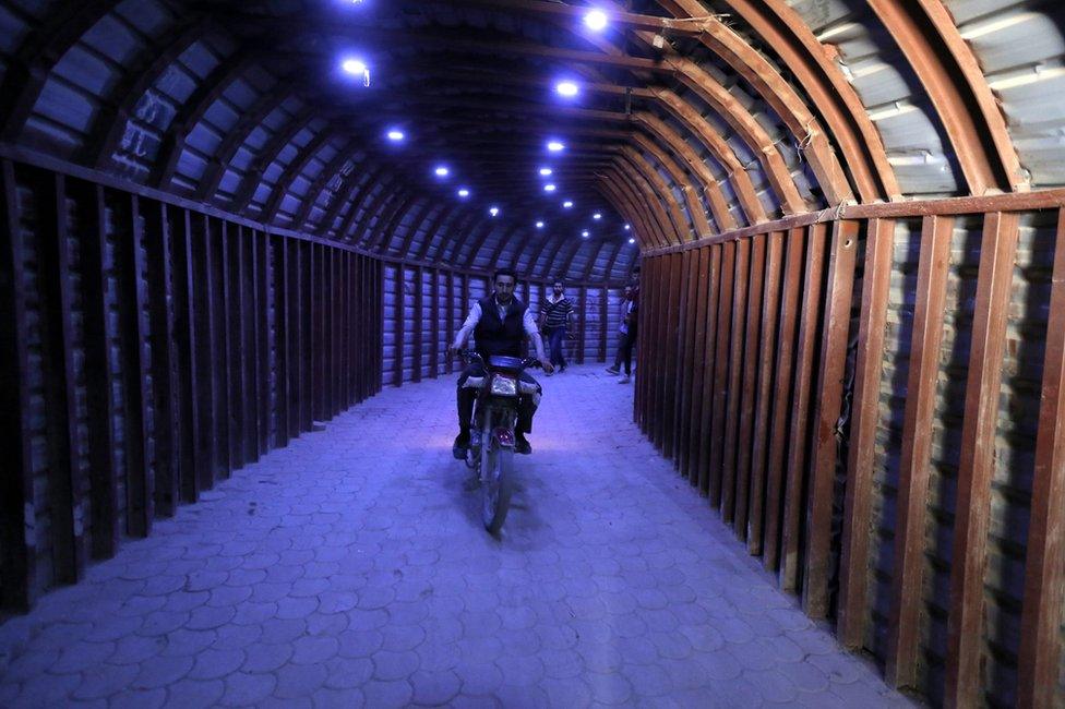 A man rides a motorcycle in a tunnel in Douma, Syria, 20 April 2018