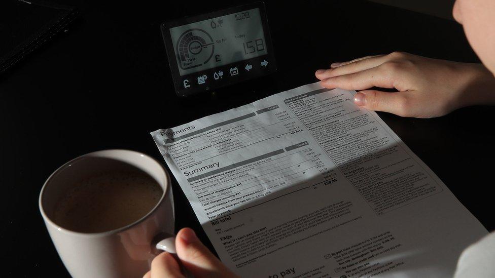 A stock image shows someone reading an energy bill