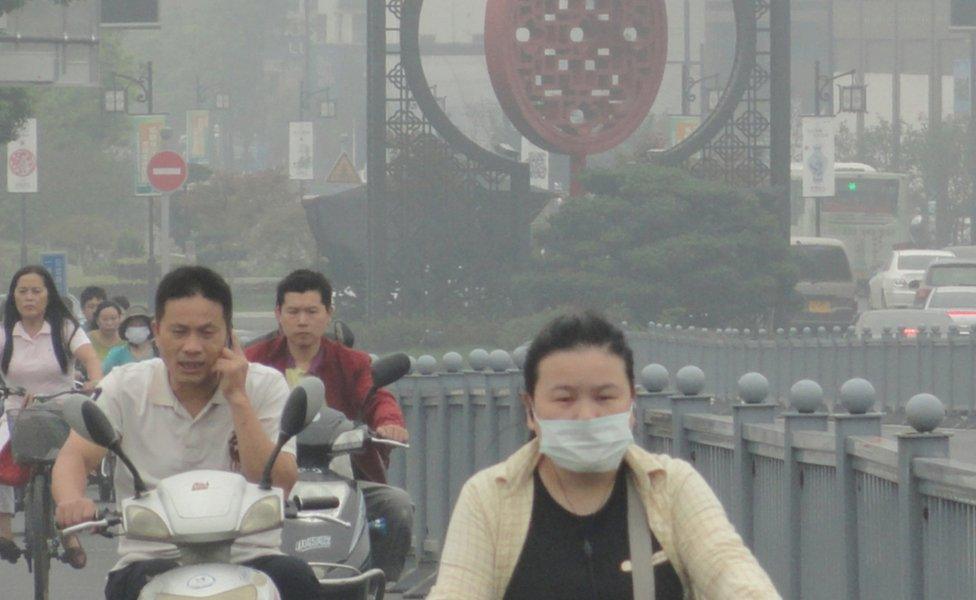 People cycling, some in face masks, in Jiangsu Province