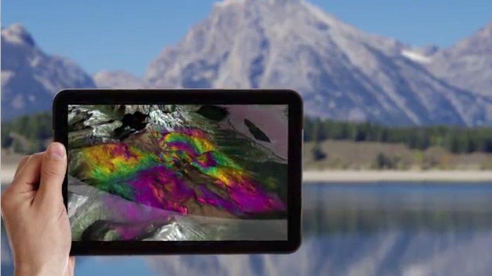 Tablet showing shortwave infrared image of mountain