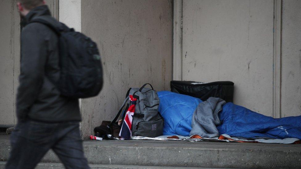 A homeless person sleeping on the street