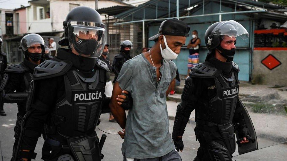 A man is arrested during a demonstration against the government of President Miguel Diaz-Canel in Arroyo Naranjo Municipality, Havana on July 12, 2021.