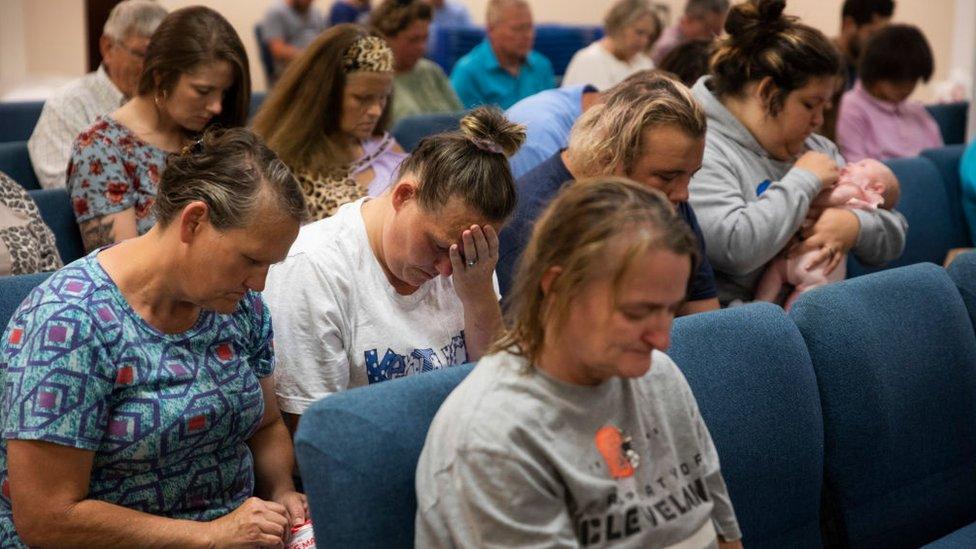 Image shows people attending a church service