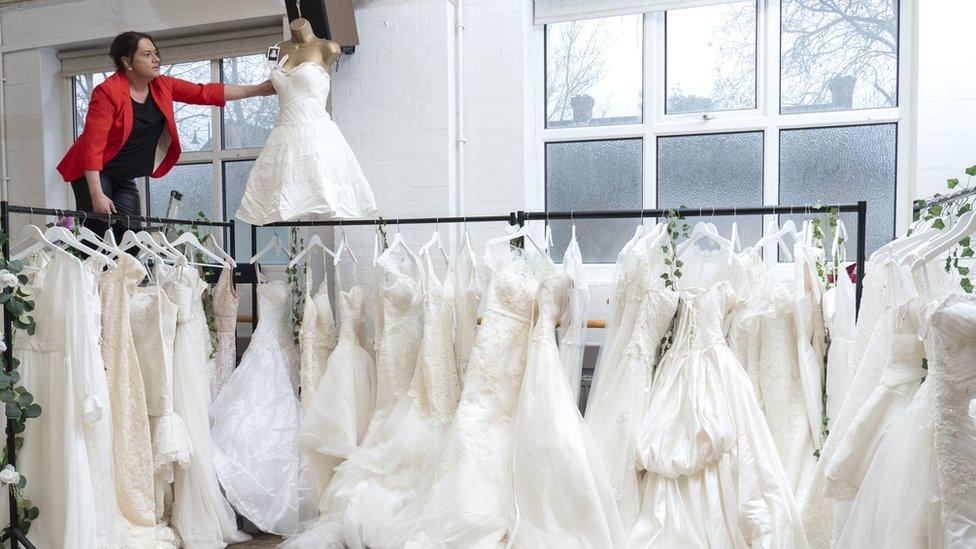 Sidcup charity shop manager Sally Todd surrounded by donated wedding dresses