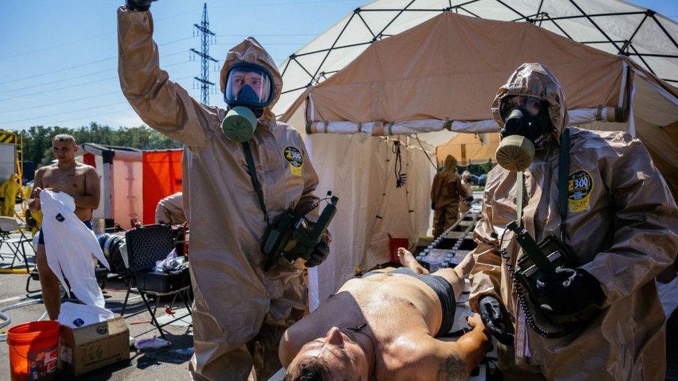 Ukrainian Emergency Ministry rescuers attend an exercise in the city of Zaporizhzhia on August 17, 2022, in case of a possible nuclear incident at the Zaporizhzhia nuclear power plant located near the city