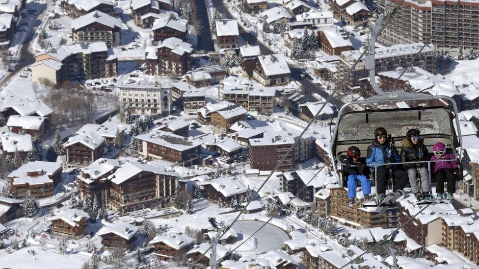 Skiers use skis lifts up the slopes at the ski resort in Val-d'Isere, in the French Alps