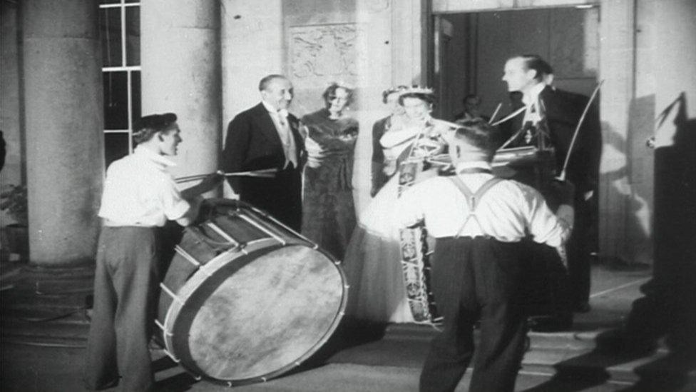 Pathe footage of the Queen and the Duke of Edinburgh as the drummers play