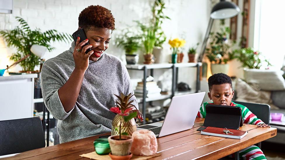 Mum working from home with her child