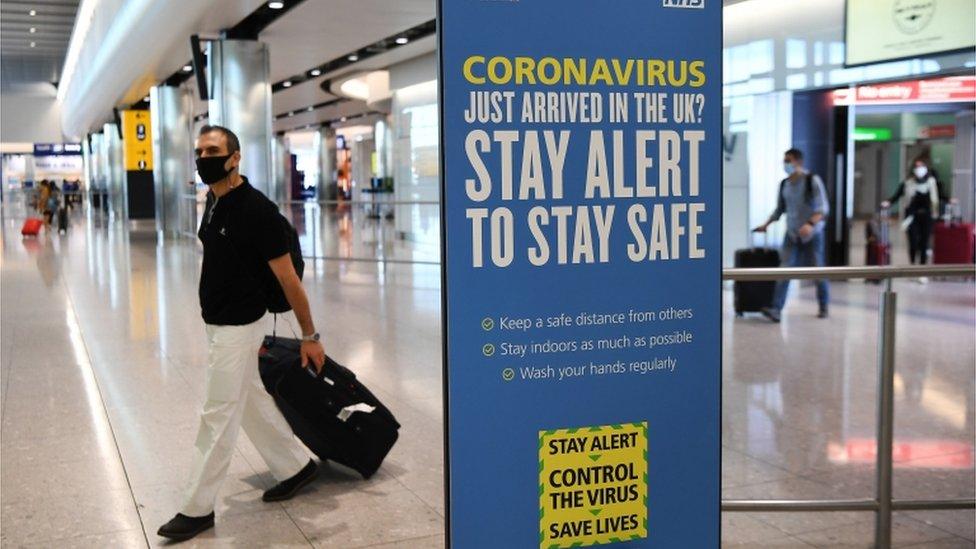 Passengers arrive at Heathrow Airport in London, Britain, 30 July 2020.