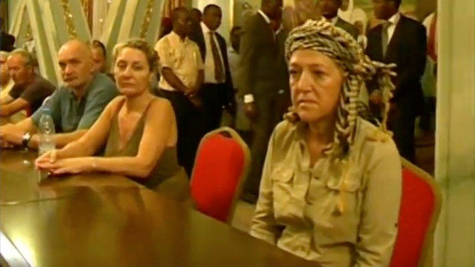 Tourists, who were held hostage, sit after they were freed in Yaounde