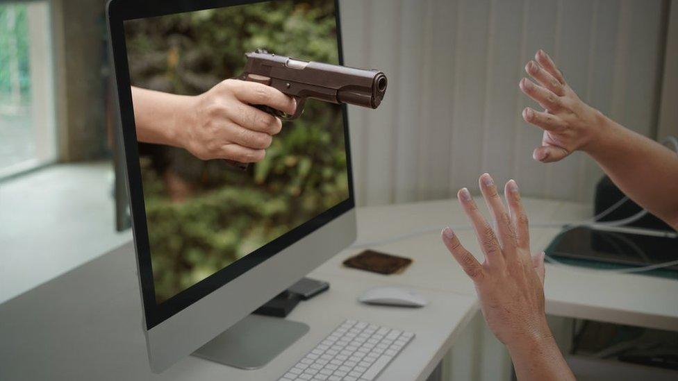 Gun appearing from computer screen