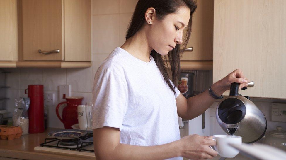 Woman boiling kettle