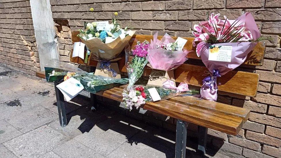 Flowers and tributes at the scene of the crash