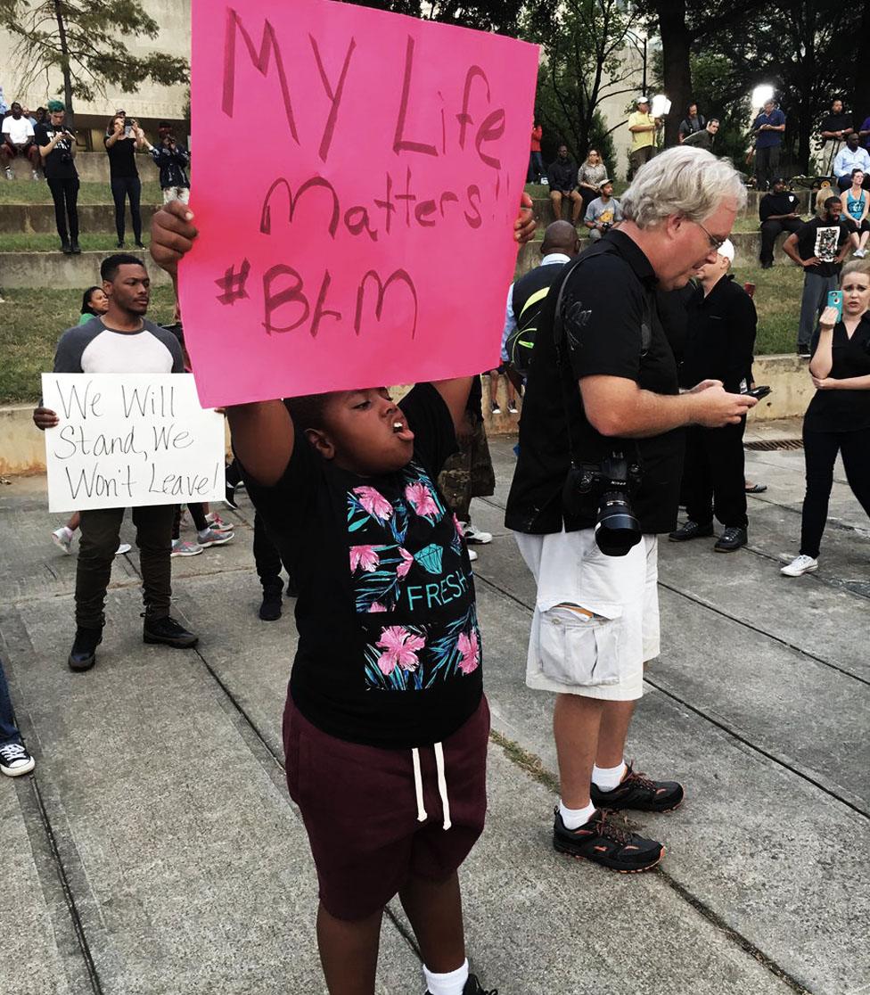 A child waves a banner saying "my life matters"