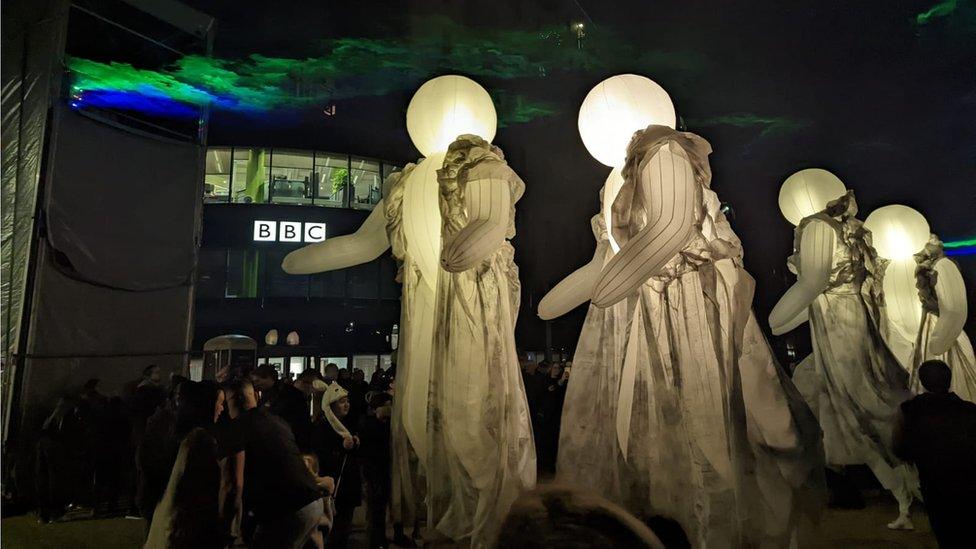 Giant puppets parading on a street