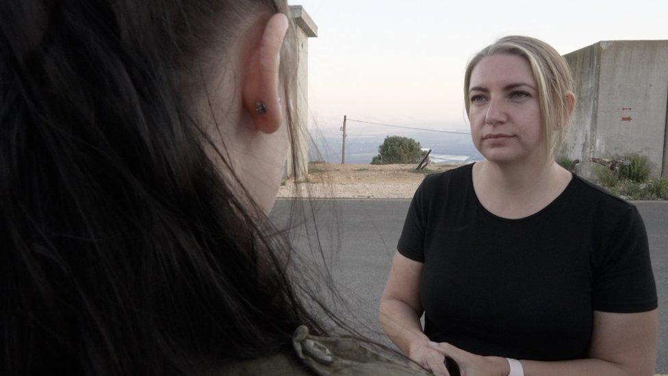 Anna Foster (R) speaks to an Israeli soldier, Sergeant "I", at a base near Israel's northern border with Israel