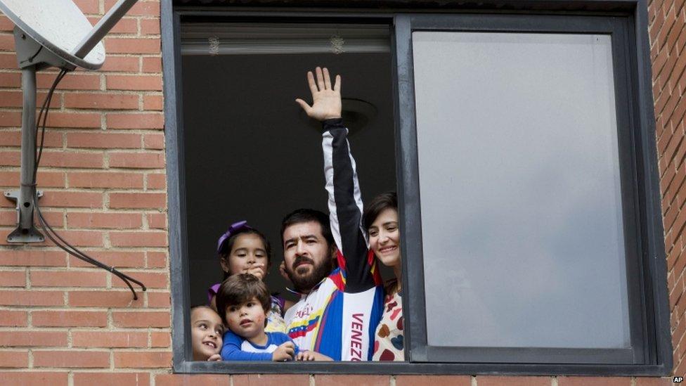 Daniel Ceballos in his Caracas flat with wife and three children